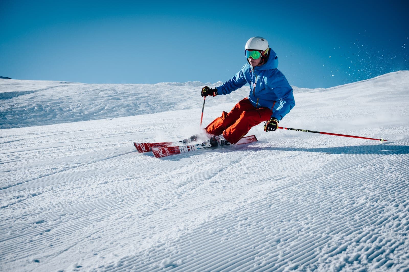 A skier carving a turn on freshly groomed corduroy